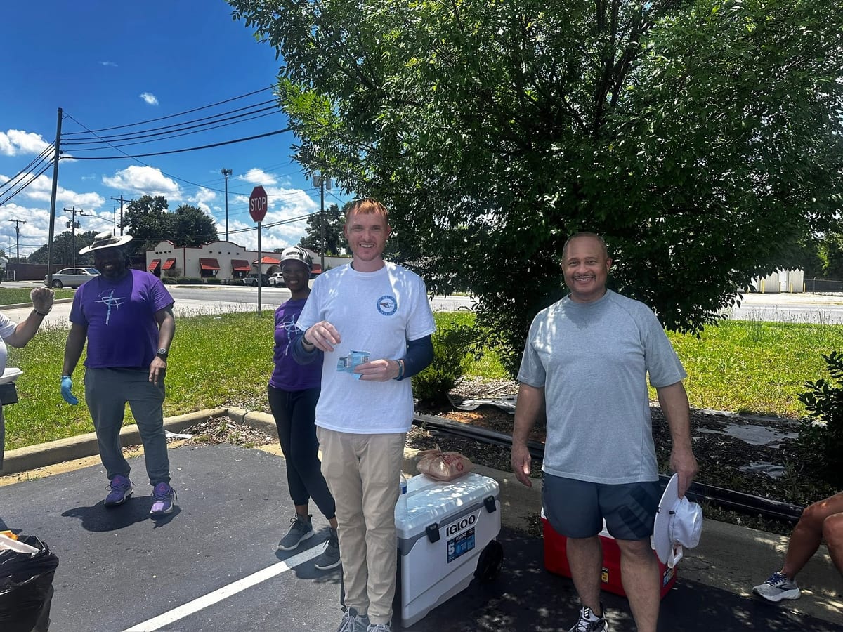 BUFC volunteers smiling at community cookout event