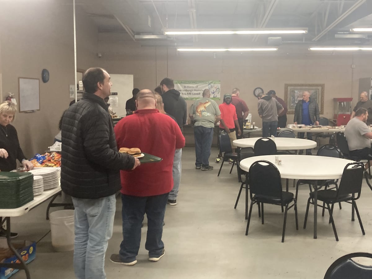 BUFC volunteers serving meals to the homeless community